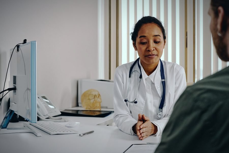 Médica en consulta con un paciente en su consultorio